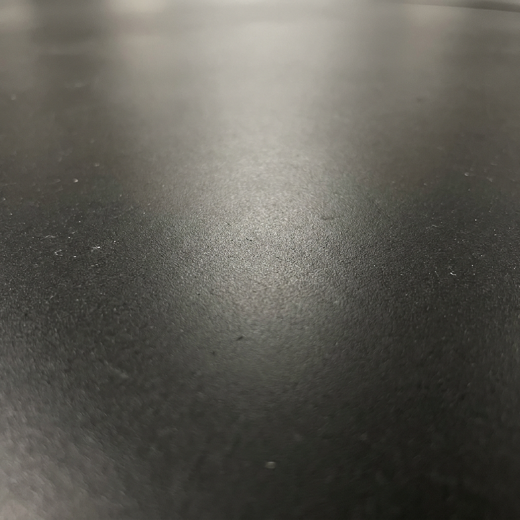 Close-up of smooth 5mm heavy-duty rubber garage flooring surface texture