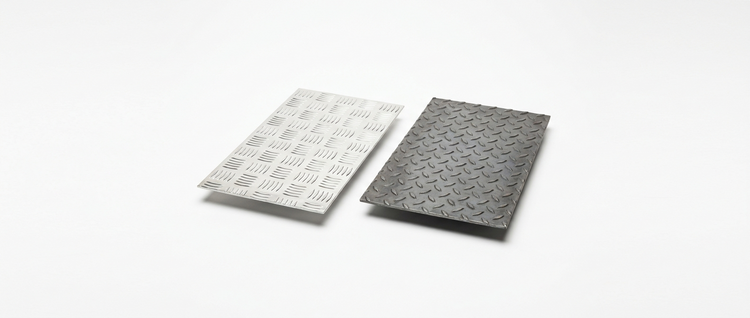 Aluminium five-bar chequer plate and steel durbar tread plate sheets on a white background