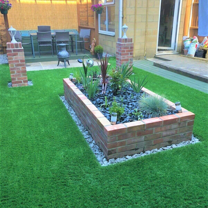 Luxury artificial grass installed in landscaped outdoor area