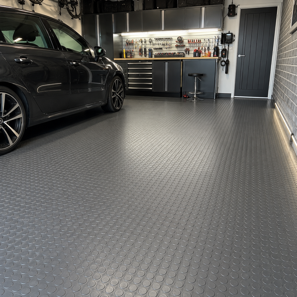 Black coin rubber flooring installed in home garage
