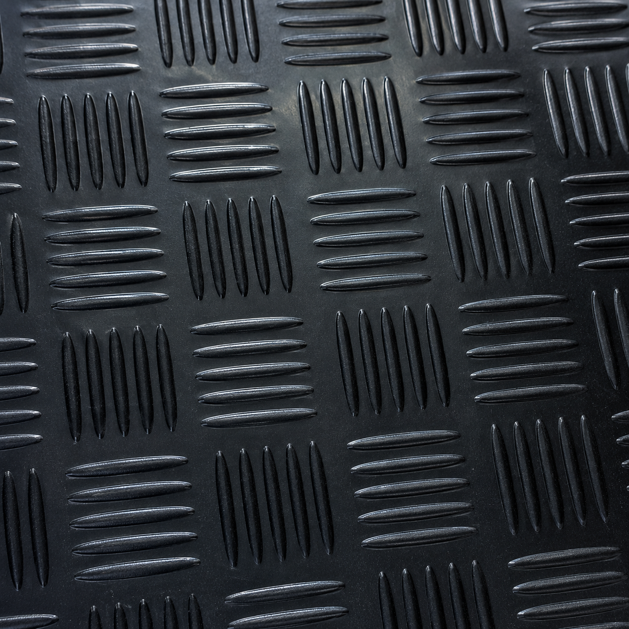 Close-up of black 1.5m wide 3mm 5 bar checker rubber flooring texture, showing pattern and finish