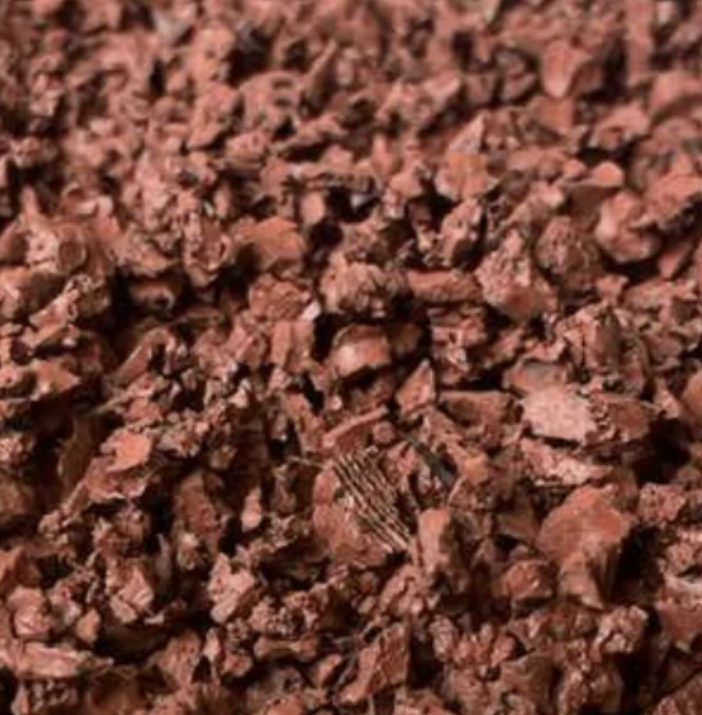 Close-up of rustic red rubber mulch chippings