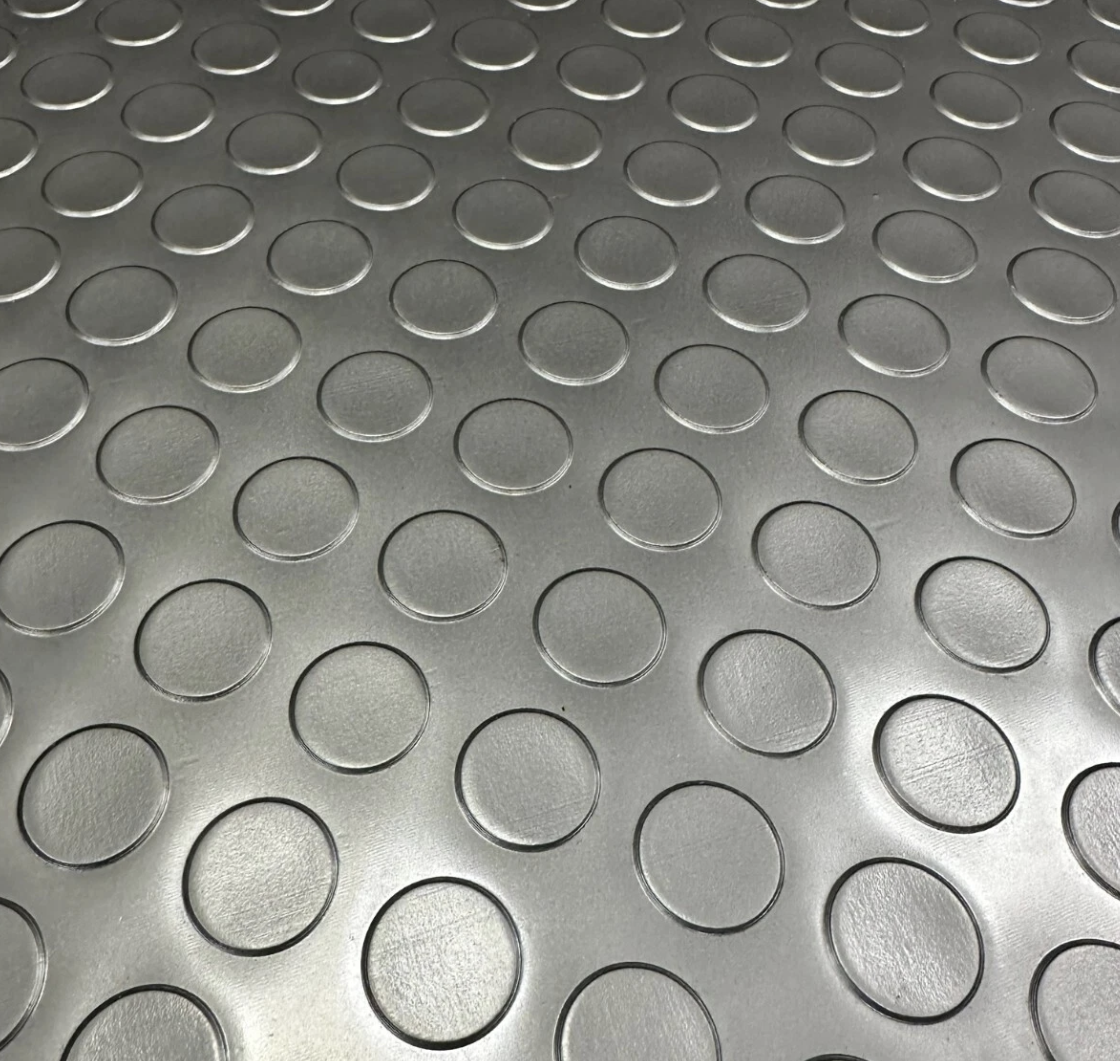 Close-up of black coin PVC garage flooring texture