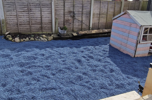 Blue playground rubber chippings installed in garden play area