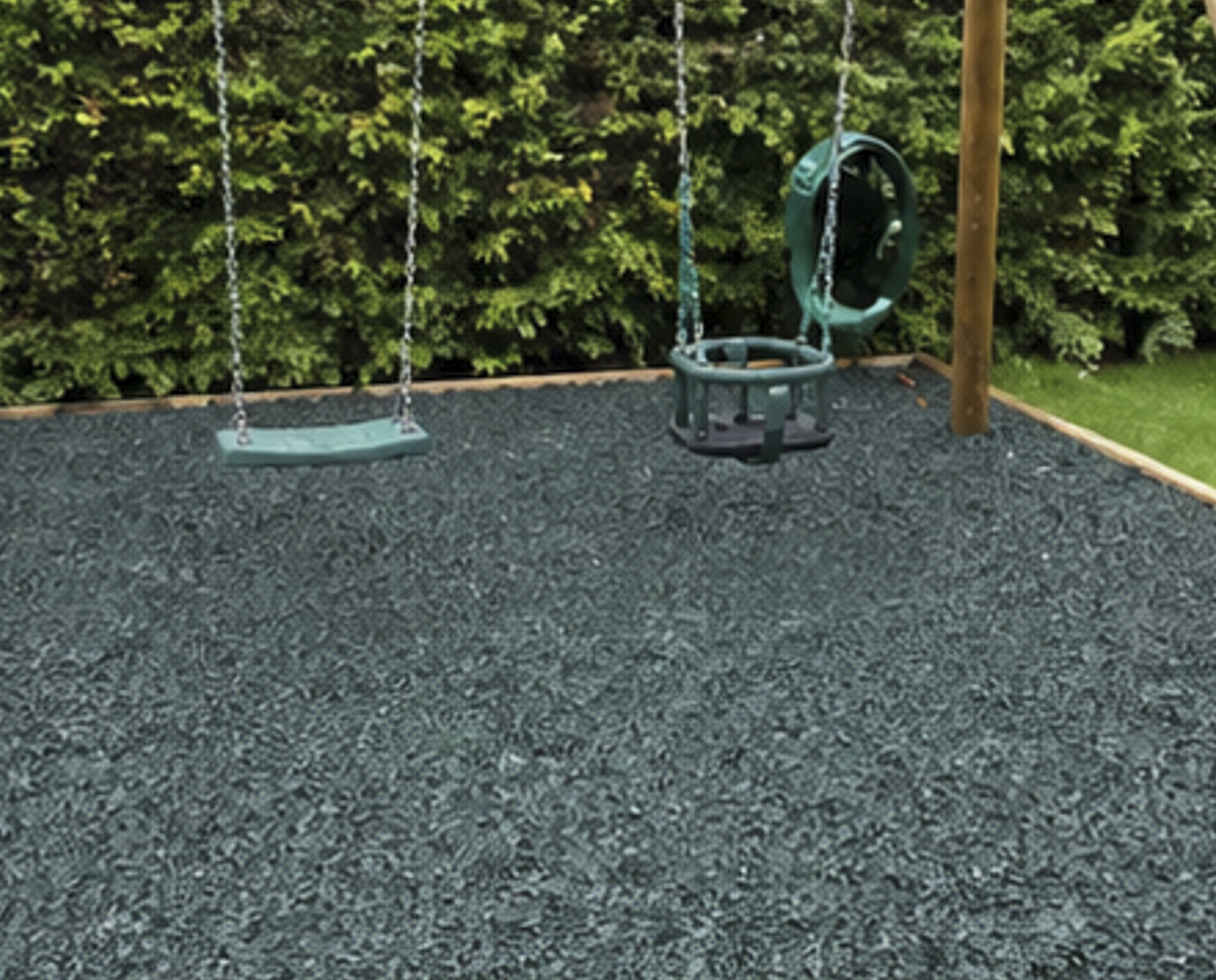 Grey playground rubber chippings under swing set