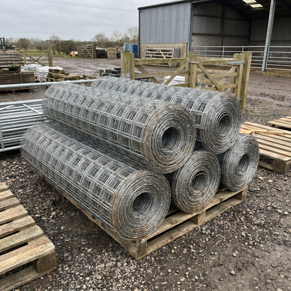 Rolls of galvanised stock fencing stacked in a farm supplies yard