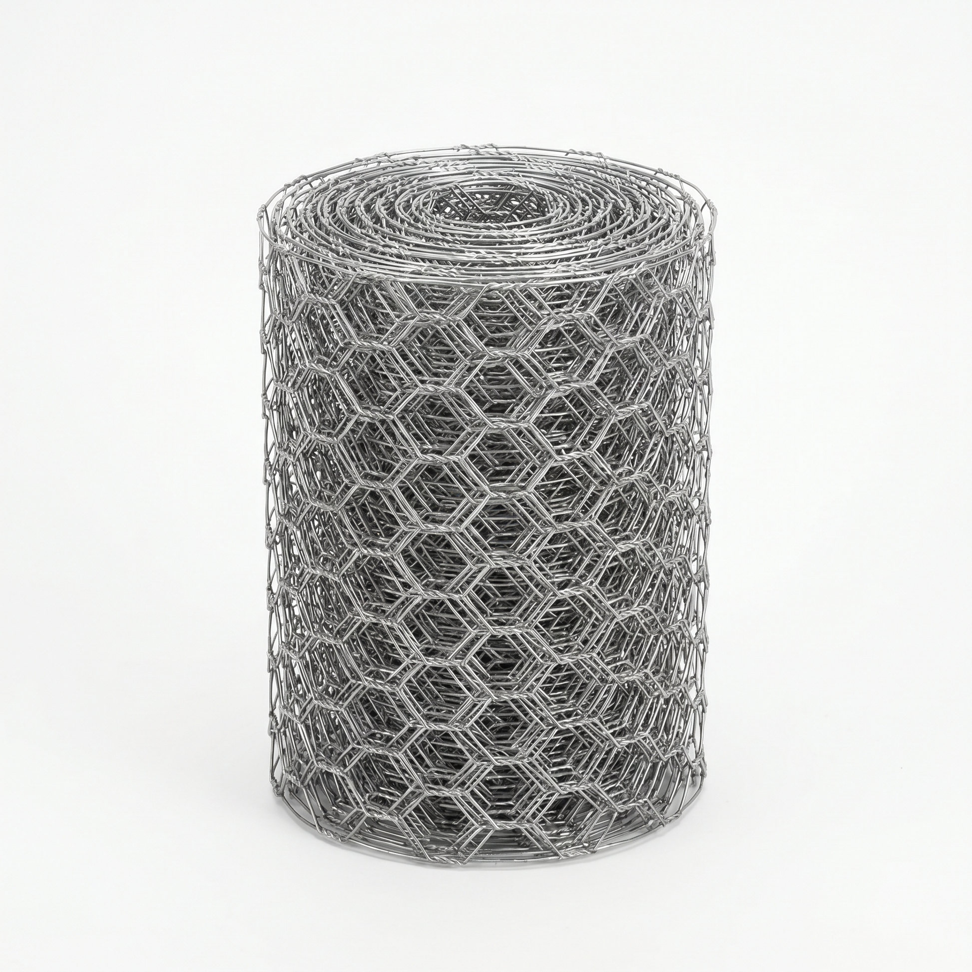 Roll of galvanised chicken wire mesh on a white studio background