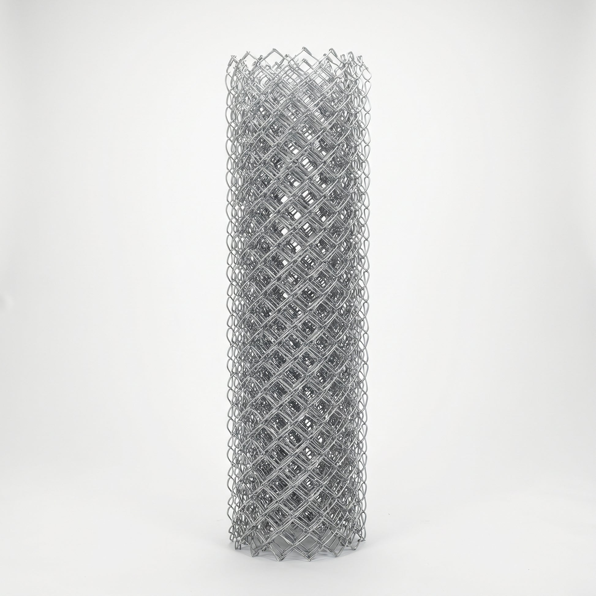 Roll of galvanised chain link fencing on a white studio background
