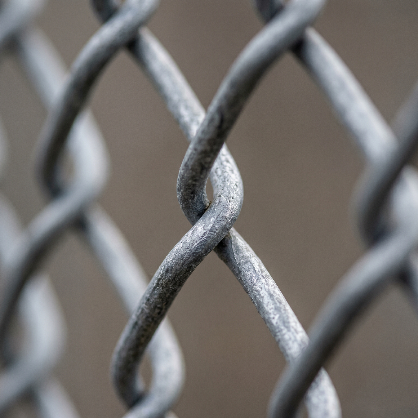 Close-up of galvanised chain link diamond mesh pattern