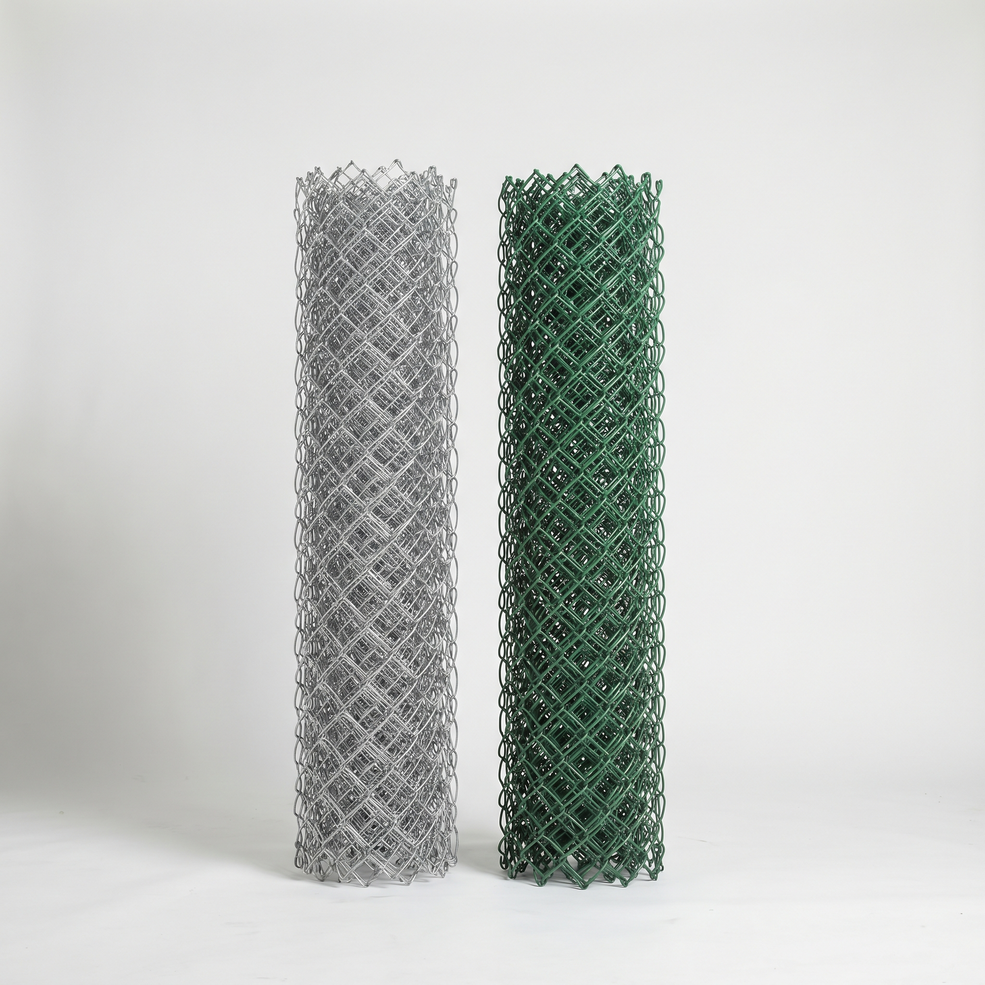Galvanised and green PVC-coated chain link rolls side by side