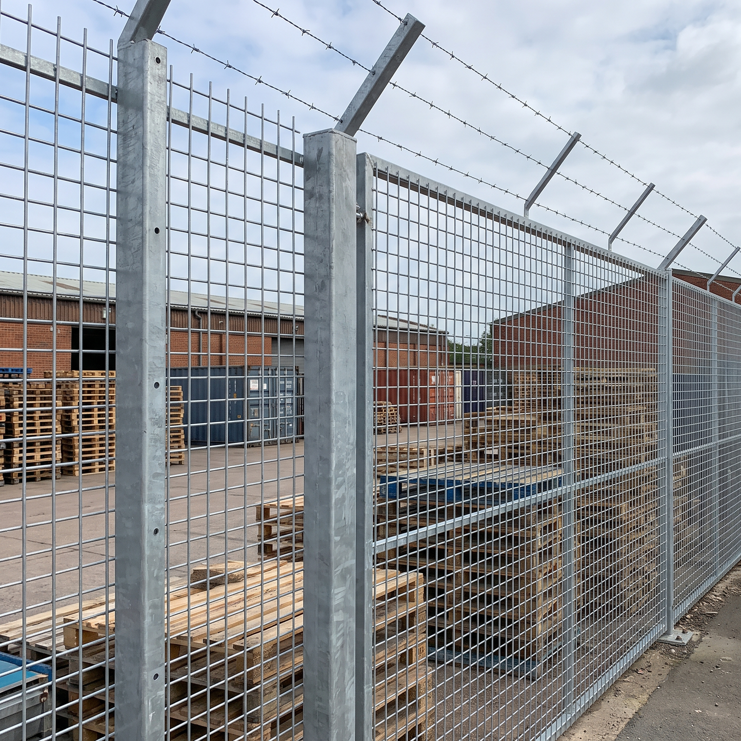 Heavy galvanised 50mm weld mesh security fence at a UK yard
