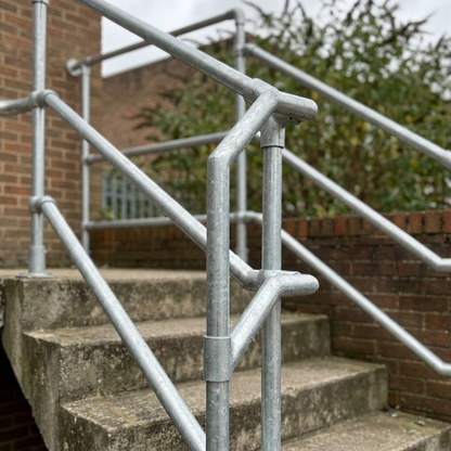 Galvanised steel tube handrail framework on a UK external staircase