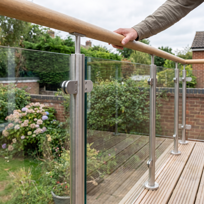 10mm toughened glass deck balustrade infill in stainless steel clamps in a UK garden