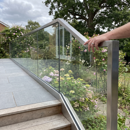 Framed clear toughened glass balustrade on a UK terrace and steps