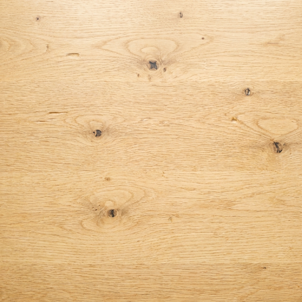 Close-up of light oak worktop surface showing natural wood grain and knots