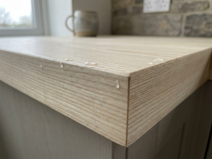 40mm solid ash worktop square edge and pale straight grain close-up