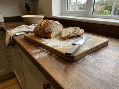 Solid walnut kitchen worktop with chopping board and bread
