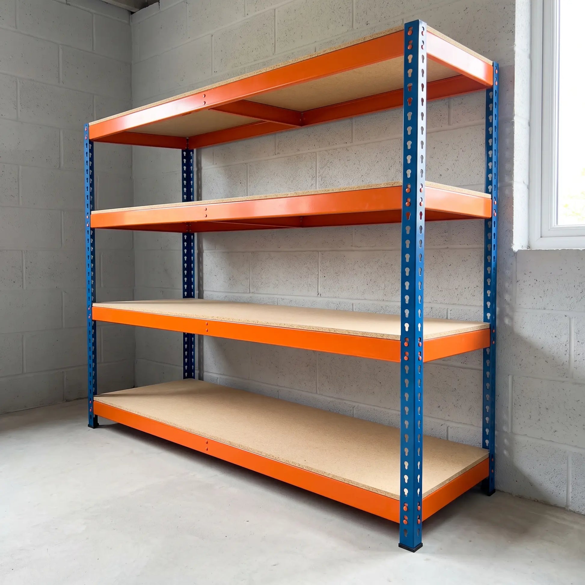 Heavy duty garage racking empty in a UK home garage, orange and blue boltless steel shelving unit