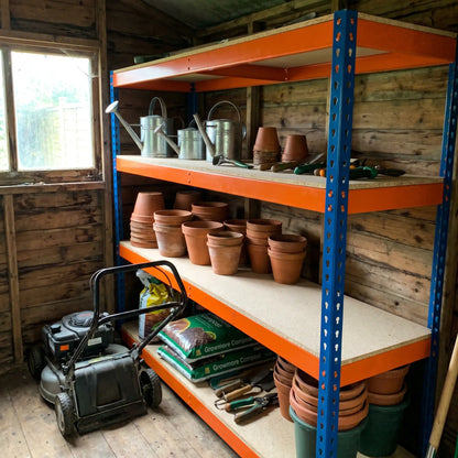 Garage racking used as garden shed shelving with plant pots, compost and hand tools