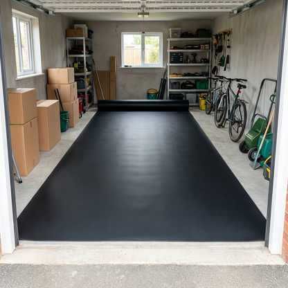 Smooth rubber matting roll rolled out across a garage floor