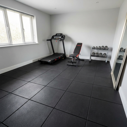 Rubber gym floor tiles in a spare-room home gym with treadmill and bench