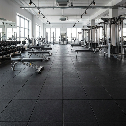 Rubber gym floor tiles in a commercial gym free-weights area